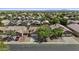 An aerial view of a neighborhood showing many homes with tile roofs and mature landscaping at 10727 E El Moro Ave, Mesa, AZ 85208