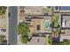 Overhead shot of a well-maintained home with solar panels and a private swimming pool surrounded by lush landscaping at 10727 E El Moro Ave, Mesa, AZ 85208