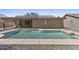 A sparkling pool sits in a well maintained backyard with solar panels on the roof at 10727 E El Moro Ave, Mesa, AZ 85208