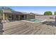 Home backyard featuring a refreshing pool, spacious patio, rock landscaping, and privacy fence at 10727 E El Moro Ave, Mesa, AZ 85208