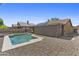 Backyard with pool, gravel landscaping, and solar panels visible on the roof at 10727 E El Moro Ave, Mesa, AZ 85208