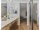 Bathroom featuring double sinks, vanity with wooden cabinets and mirrors for a functional design at 10727 E El Moro Ave, Mesa, AZ 85208