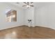 Bedroom features wood floors, white walls, and a ceiling fan at 10727 E El Moro Ave, Mesa, AZ 85208