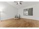 Bedroom features wood floors, white walls, and a ceiling fan at 10727 E El Moro Ave, Mesa, AZ 85208