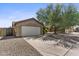 Side view of a home featuring a two-car garage, desert landscaping, and security features at 10727 E El Moro Ave, Mesa, AZ 85208