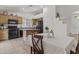 Bright eat in kitchen area with black appliances, wooden cabinetry, and an island for cooking at 10727 E El Moro Ave, Mesa, AZ 85208
