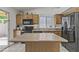 Spacious kitchen featuring an island, tile flooring, stainless steel appliances, and wood cabinetry at 10727 E El Moro Ave, Mesa, AZ 85208