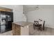 Open kitchen featuring an island, stainless steel appliances, and modern design with a breakfast nook at 10727 E El Moro Ave, Mesa, AZ 85208