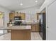 Well-lit kitchen with island, ample counter space, black appliances, and plenty of cabinet storage at 10727 E El Moro Ave, Mesa, AZ 85208