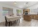 Eat in kitchen with wooden cabinets, island, tile flooring, and natural light from the sliding glass doors at 10727 E El Moro Ave, Mesa, AZ 85208