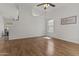 Bright living room features wood floors, white walls, and an abundance of natural light at 10727 E El Moro Ave, Mesa, AZ 85208