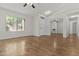 Large living room with hardwood floors, white walls, and views of other areas of the house at 10727 E El Moro Ave, Mesa, AZ 85208