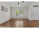 Bright living room features wood floors, white walls, and an abundance of natural light at 10727 E El Moro Ave, Mesa, AZ 85208