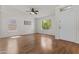 Bright living room features wood floors, white walls, and an abundance of natural light at 10727 E El Moro Ave, Mesa, AZ 85208