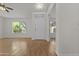 Bright living room with white walls, wood floors, and a large window with neighborhood views at 10727 E El Moro Ave, Mesa, AZ 85208