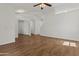Spacious living room featuring white walls, high ceilings, and wood floors throughout at 10727 E El Moro Ave, Mesa, AZ 85208