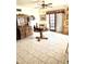 Dining area with tile floors, oak cabinets, and a glass door to the backyard at 1231 E Avila Ave, Casa Grande, AZ 85122