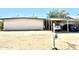 Single story home with a brick facade, carport, desert landscaping and a mailbox at 1231 E Avila Ave, Casa Grande, AZ 85122