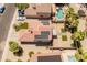 Aerial view showcases home's roof-mounted solar panels, backyard oasis with pool, and lush landscaping at 1374 E 10Th Pl, Casa Grande, AZ 85122