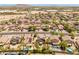 A birds-eye view of the neighborhood showcases the homes with desert landscaping and tile roofs at 1374 E 10Th Pl, Casa Grande, AZ 85122