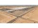 Wide aerial view of a large industrial complex with buildings, parking lots, roads, and desert terrain at 1374 E 10Th Pl, Casa Grande, AZ 85122