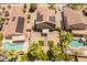 An aerial view shows the house features a backyard with a pool, palm trees, and desert landscaping at 1374 E 10Th Pl, Casa Grande, AZ 85122