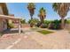 Low-maintenance backyard features desert landscaping, decorative pavers, and mature palm trees at 1374 E 10Th Pl, Casa Grande, AZ 85122