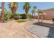 Spacious backyard with artificial turf, palm trees, and a covered patio, creating a relaxing outdoor oasis at 1374 E 10Th Pl, Casa Grande, AZ 85122