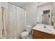 Cozy bathroom features a shower-tub combination with a patterned shower curtain and a wood-finish vanity at 1374 E 10Th Pl, Casa Grande, AZ 85122