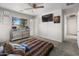 Spacious bedroom featuring carpet floors, a ceiling fan, a window, and a TV at 1374 E 10Th Pl, Casa Grande, AZ 85122