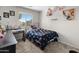Bedroom with a large window offering natural light and carpeted floors at 1374 E 10Th Pl, Casa Grande, AZ 85122