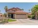 Inviting two-story home boasts a manicured front yard, mature palm trees, and a spacious two-car garage at 1374 E 10Th Pl, Casa Grande, AZ 85122