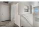 Hallway featuring carpet floors, white walls, and railing with a window at 1374 E 10Th Pl, Casa Grande, AZ 85122
