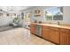 Well-designed kitchen with stainless steel dishwasher, sink and access to the living room at 1374 E 10Th Pl, Casa Grande, AZ 85122