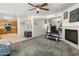 Open-concept living area with fireplace, TV, and access to a modern kitchen with natural light at 1374 E 10Th Pl, Casa Grande, AZ 85122