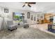 Bright living room with French doors leading outside, stylish patterned chairs and an adjacent kitchen at 1374 E 10Th Pl, Casa Grande, AZ 85122