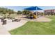 Outdoor playground features covered picnic area, play structure with slide, swings, and open green spaces at 1374 E 10Th Pl, Casa Grande, AZ 85122