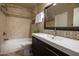 Updated bathroom featuring tile walls, vanity, mirror, and shower-tub combination at 1401 E Puget Ave # 24, Phoenix, AZ 85020