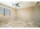 Bedroom featuring tile floors, ceiling fan, large window, and mirrored closet at 1401 E Puget Ave # 24, Phoenix, AZ 85020