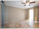 Inviting bedroom featuring tile floors, a ceiling fan, and bright natural light at 1401 E Puget Ave # 24, Phoenix, AZ 85020