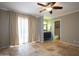 Bedroom with tile floor featuring bathroom entrance, ceiling fan, and large window at 1401 E Puget Ave # 24, Phoenix, AZ 85020