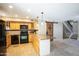 Well-lit kitchen featuring granite countertops, wooden cabinets, and black appliances at 1401 E Puget Ave # 24, Phoenix, AZ 85020