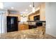 Updated kitchen with granite countertops, stainless appliances, and recessed lighting at 1401 E Puget Ave # 24, Phoenix, AZ 85020