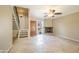 Bright living room with stone flooring, fireplace, ceiling fan, and staircase to the upper level at 1401 E Puget Ave # 24, Phoenix, AZ 85020