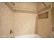 Elegant shower features decorative tile, tiled walls, and a built-in niche for toiletries at 1401 E Puget Ave # 24, Phoenix, AZ 85020