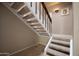 Carpeted staircase with dark iron railing leading to the upper level of the home at 1401 E Puget Ave # 24, Phoenix, AZ 85020