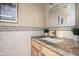 Updated bathroom featuring granite counters, tile backsplash, and wooden cabinets at 1401 E Puget Ave # 24, Phoenix, AZ 85020