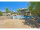A spacious backyard with a covered patio above, and a charming pool surrounded by desert landscaping at 1419 E Las Palmaritas Dr, Phoenix, AZ 85020