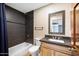 Modern bathroom features a gray backsplash, dark accents, and a classic vanity at 1419 E Las Palmaritas Dr, Phoenix, AZ 85020