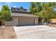 Contemporary stucco home featuring a two-car garage with a concrete driveway and mature trees in the front yard at 1419 E Las Palmaritas Dr, Phoenix, AZ 85020